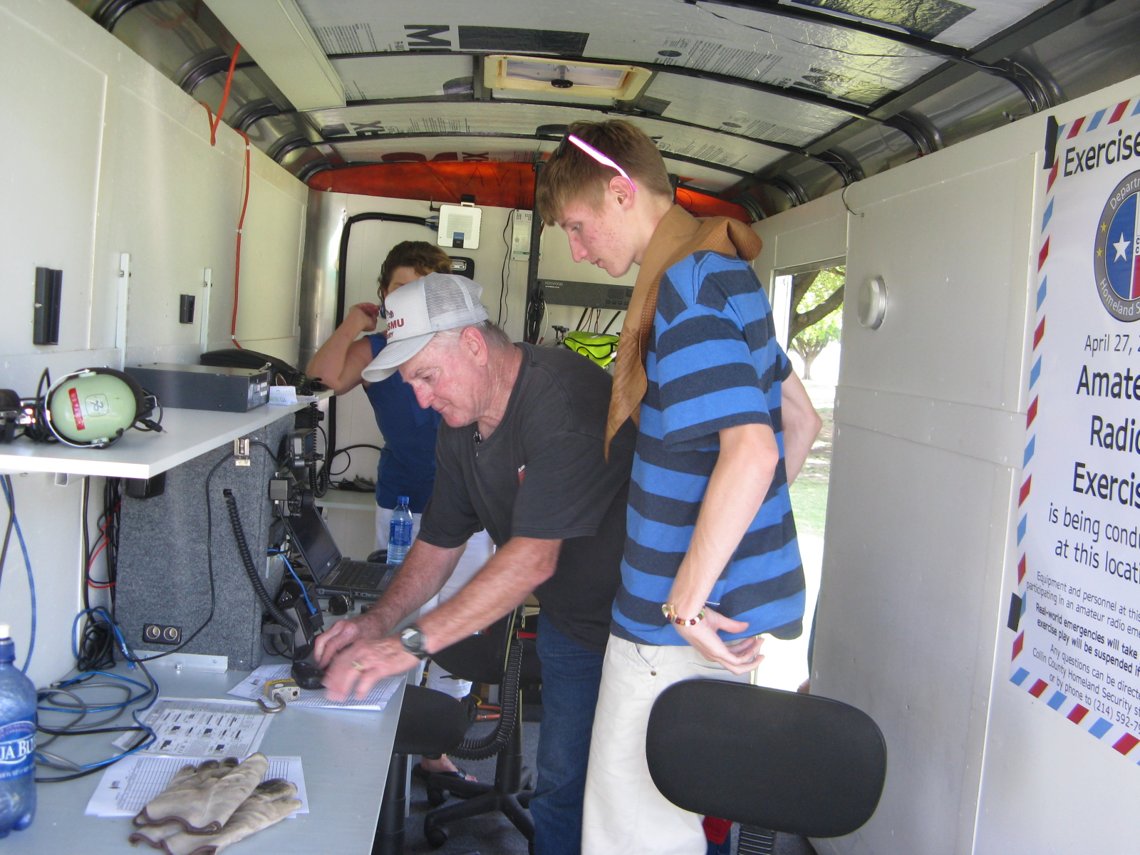 Perry showing chase how to operate the communications trailer