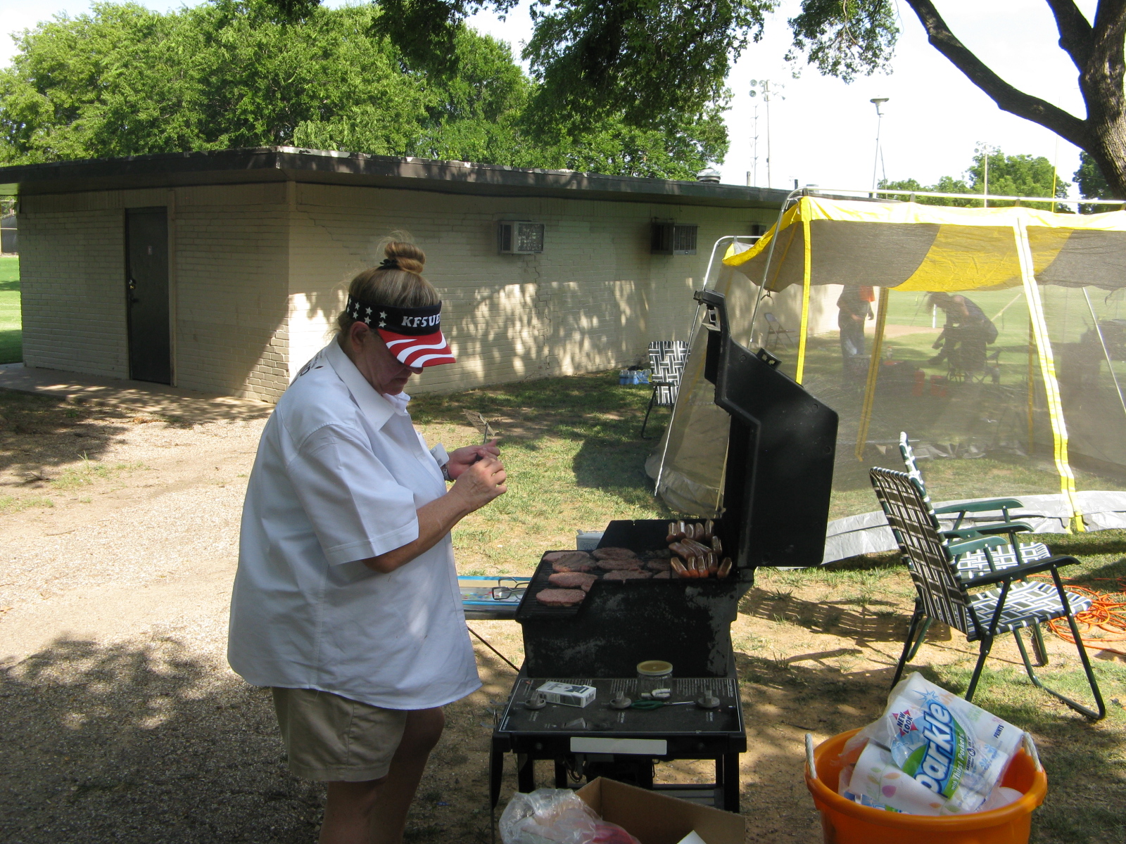 Kathy cooking burgers and dogs