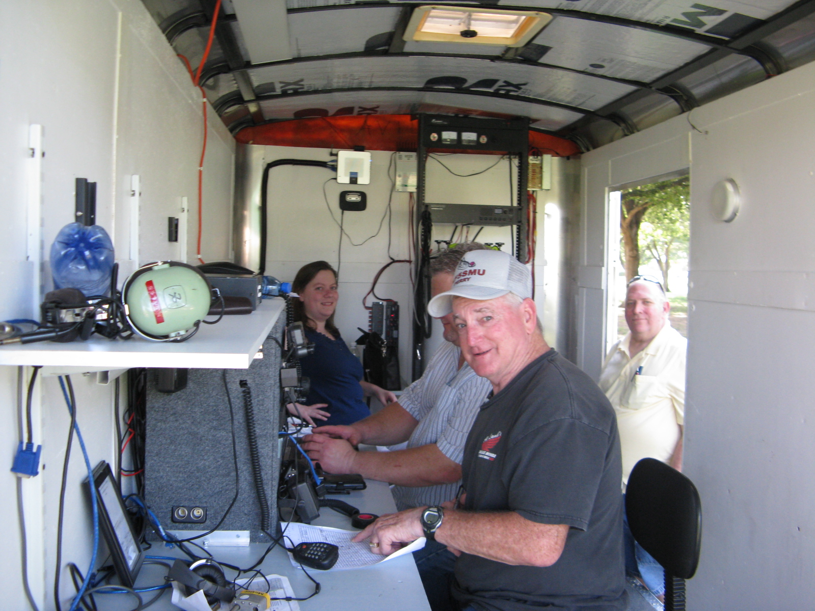 Katie, Don, Perry, and LD inside the communication trailer